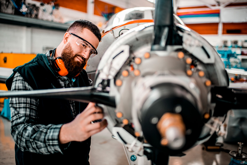 JAGGAER Aerospace & Defense Procurement - Man Working on Airplane Engine