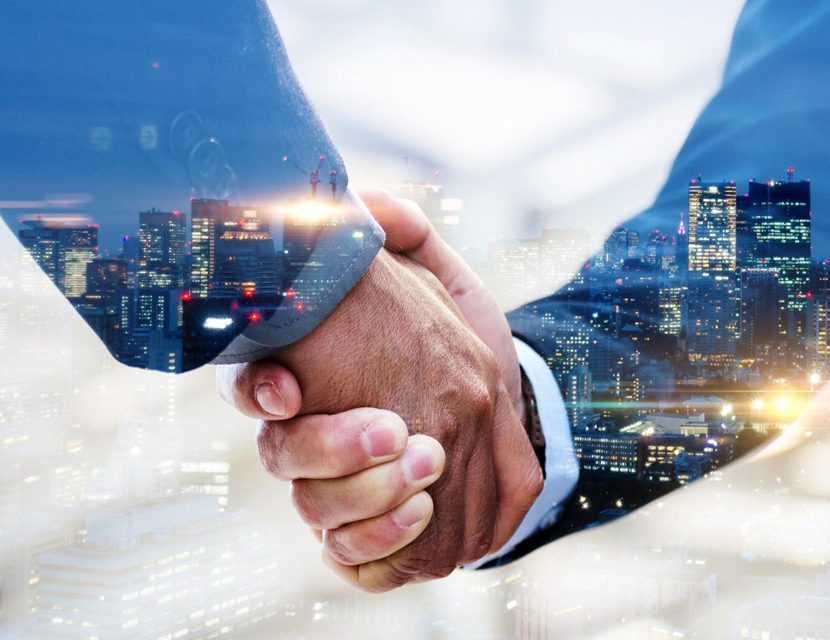 Two Men Shaking Hands with a Cityscape in the Background