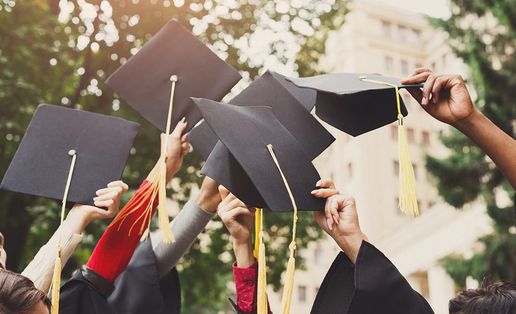 Procurement Education Vertical - Students with Graduation Caps in Air