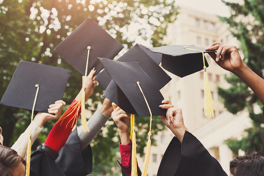 Procurement Education Vertical - Students with Graduation Caps in Air