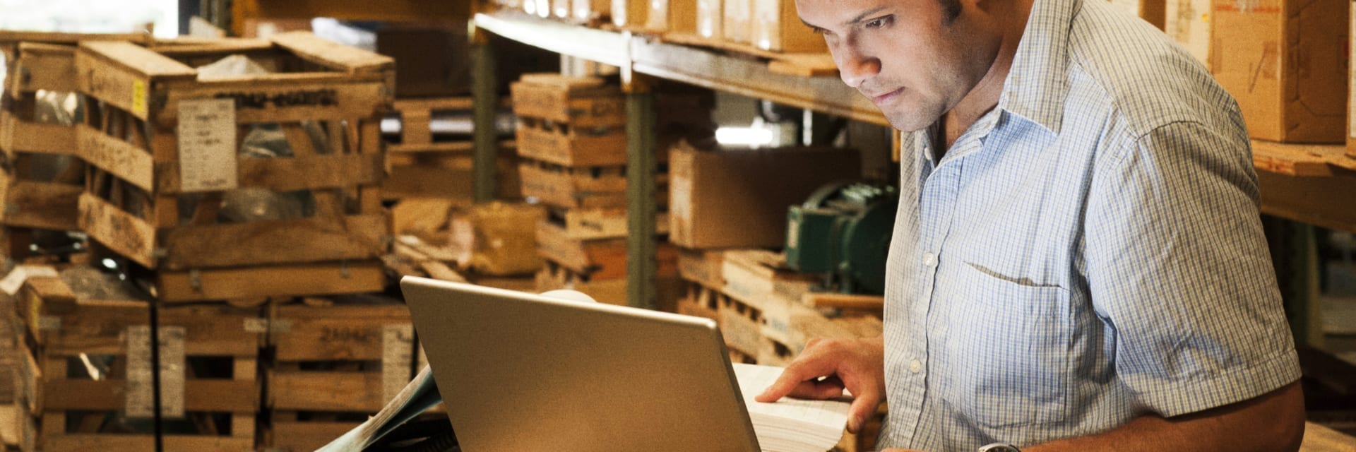 Warehouse manager working on laptop